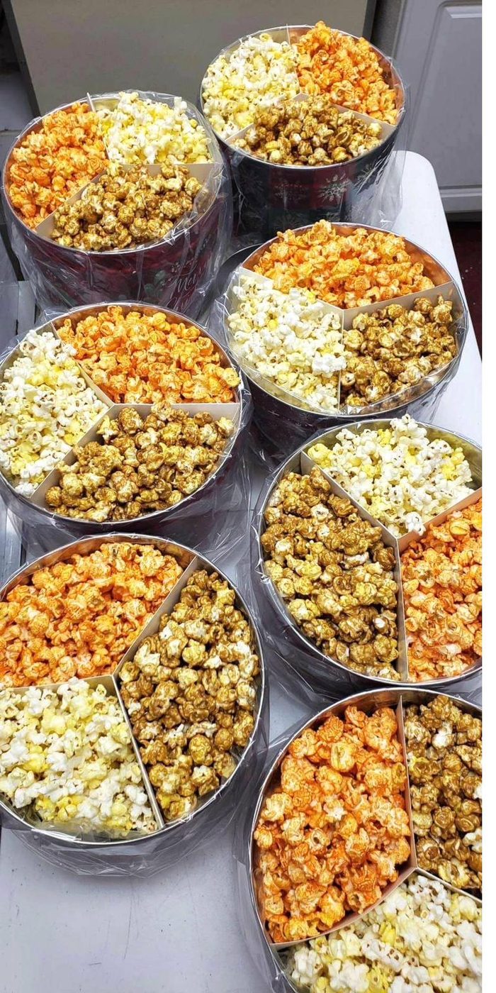 Three-flavor popcorn tins arranged in stacks